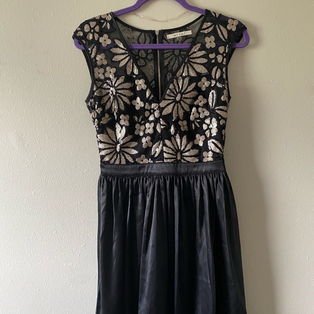 Francesca’s black and gold dress